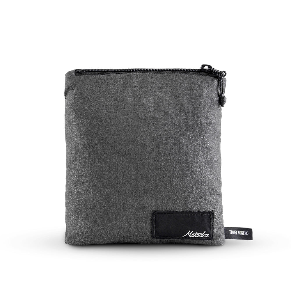 packed up charcoal poncho on white background