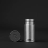 Front of canister with lid off on black background